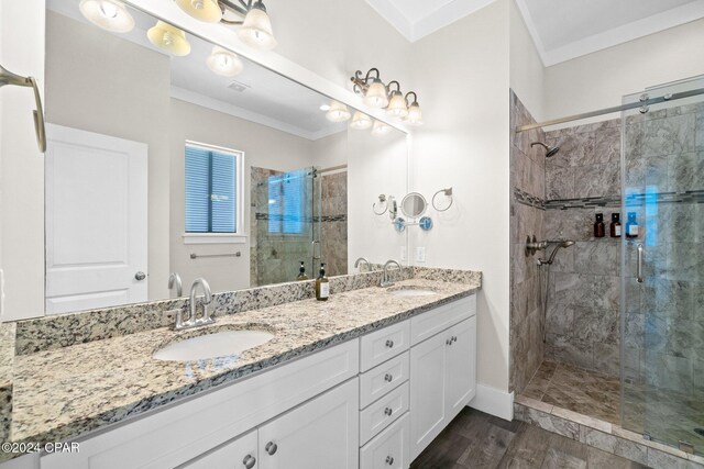 bathroom featuring hardwood / wood-style floors, vanity, an enclosed shower, and ornamental molding