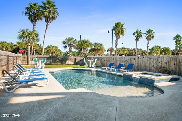 view of swimming pool with a patio area and an in ground hot tub