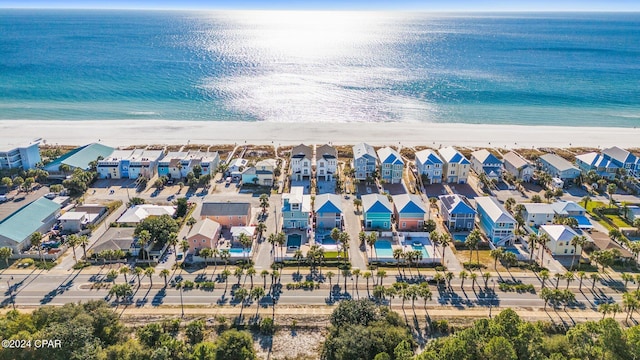 birds eye view of property with a view of the beach and a water view