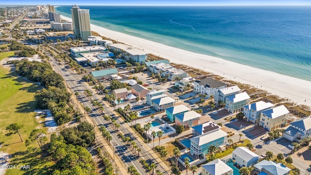 birds eye view of property with a water view and a beach view