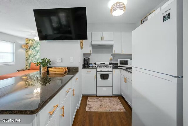 kitchen featuring white cabinets, dark hardwood / wood-style flooring, white appliances, and dark stone countertops