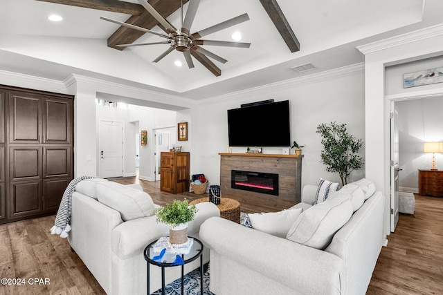 living room with ceiling fan, dark hardwood / wood-style flooring, lofted ceiling with beams, and ornamental molding