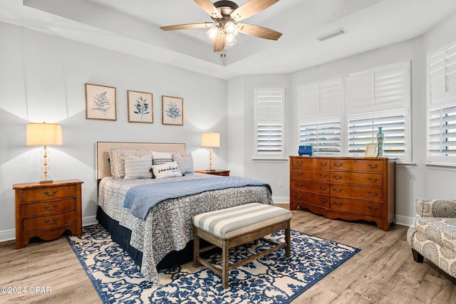 bedroom with light hardwood / wood-style flooring and ceiling fan