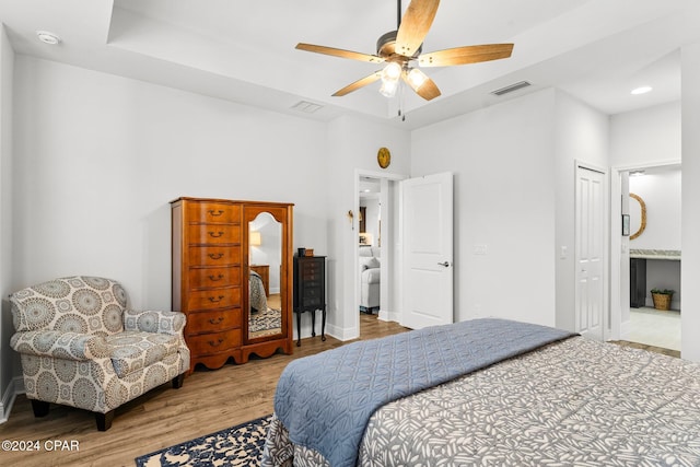 bedroom featuring ceiling fan, light wood-type flooring, and a closet