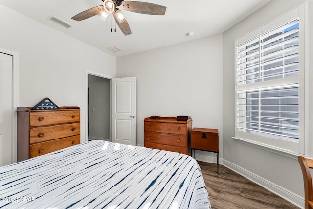 bedroom with ceiling fan and dark hardwood / wood-style floors