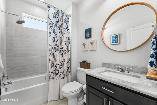 full bathroom featuring shower / bathtub combination with curtain, vanity, and toilet