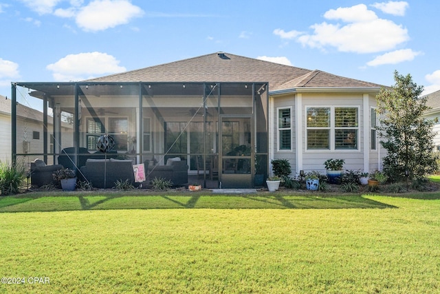 rear view of property with a lawn, glass enclosure, and an outdoor hangout area