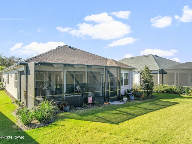 rear view of house featuring glass enclosure and a yard