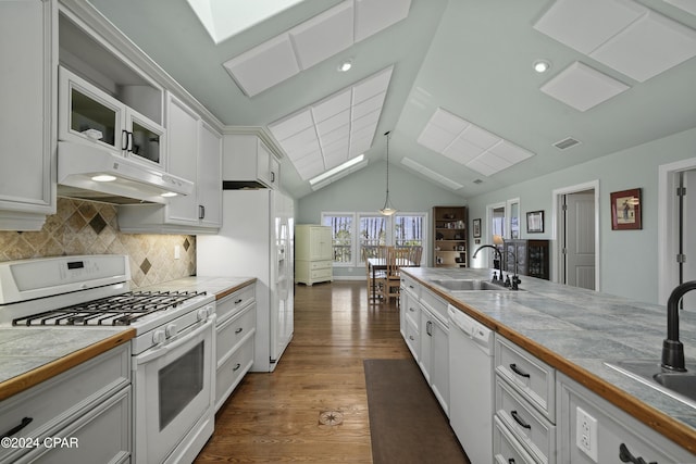 kitchen featuring dark hardwood / wood-style floors, white cabinets, decorative light fixtures, and white appliances