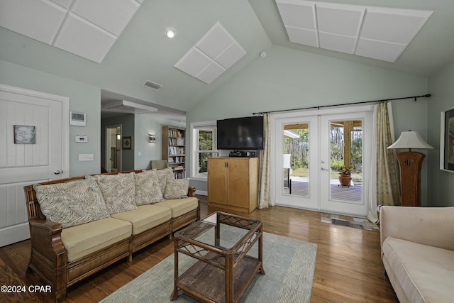 living room with hardwood / wood-style flooring, lofted ceiling, and french doors