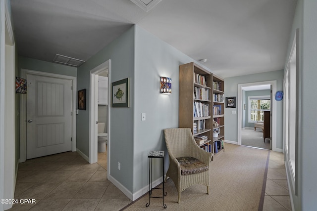 hall with light tile patterned floors