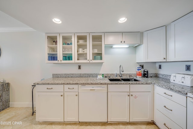 kitchen featuring glass insert cabinets, white cabinets, a sink, light stone countertops, and dishwasher