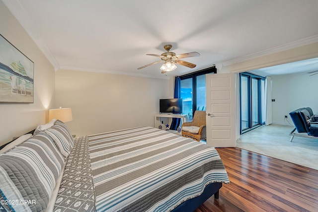 bedroom featuring baseboards, wood finished floors, a ceiling fan, and crown molding