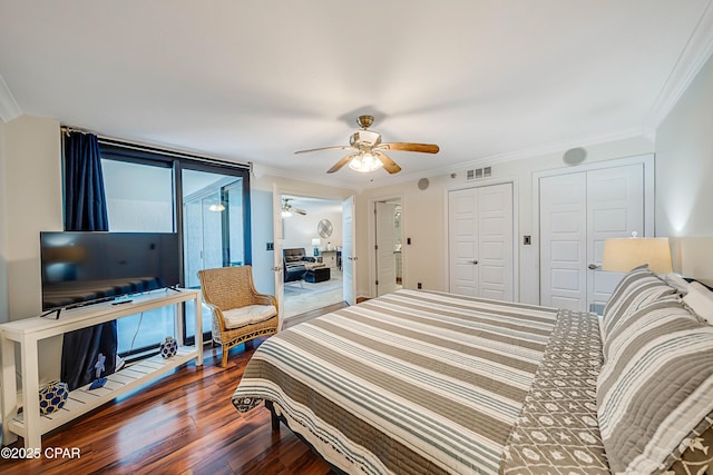 bedroom with ornamental molding, access to outside, visible vents, and wood finished floors