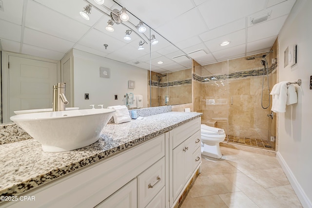 bathroom featuring a stall shower, baseboards, toilet, tile patterned floors, and vanity