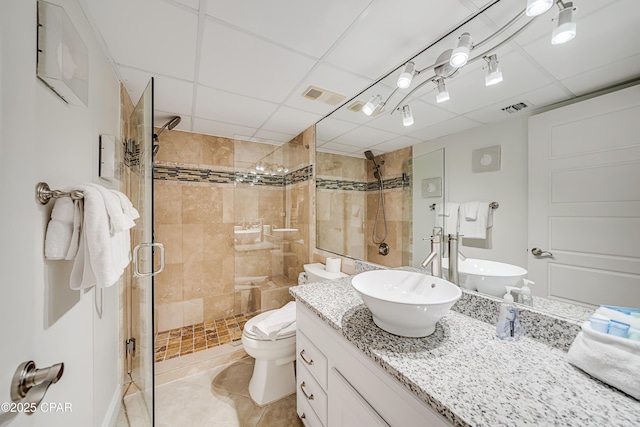 full bathroom with toilet, a shower stall, visible vents, and vanity