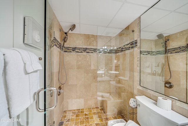 bathroom featuring a shower stall and toilet