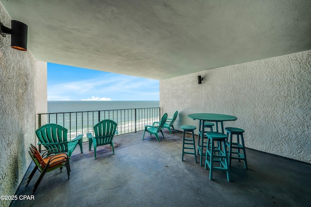 view of patio / terrace featuring a water view and a balcony