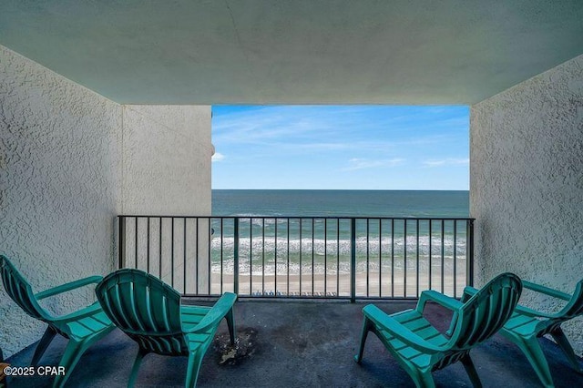 balcony with a water view and a beach view