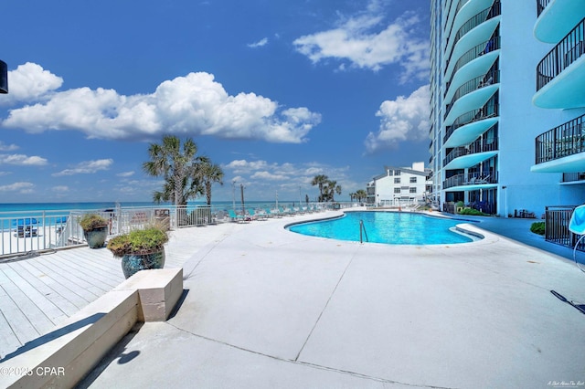 pool with a water view and a patio