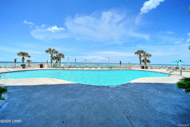 community pool with fence and a patio