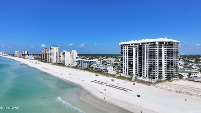 drone / aerial view featuring a view of the beach, a water view, and a view of city