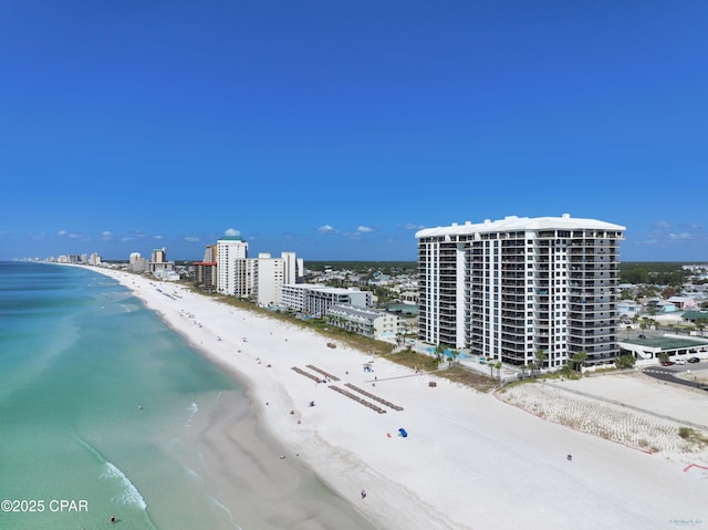 birds eye view of property featuring a city view, a water view, and a beach view