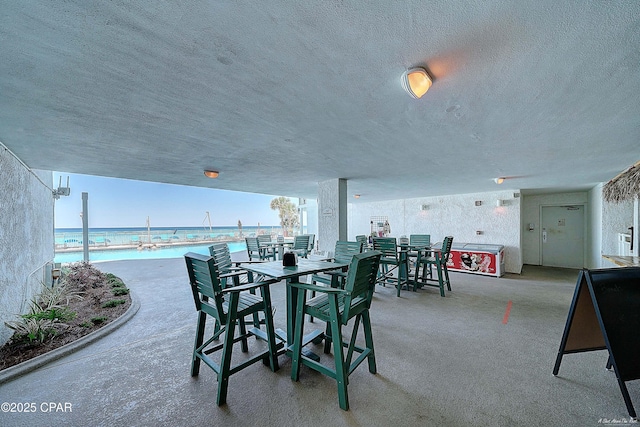 view of patio / terrace with a water view and outdoor dining space