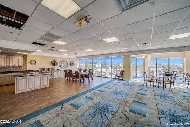 dining space with visible vents and a drop ceiling