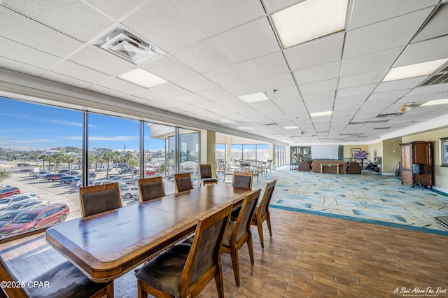 dining area with a paneled ceiling and visible vents