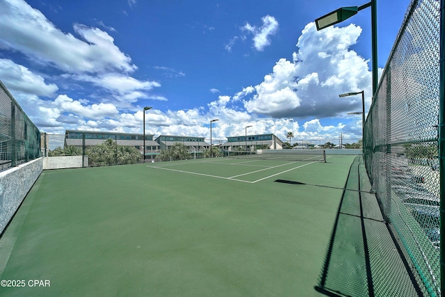 view of sport court featuring fence