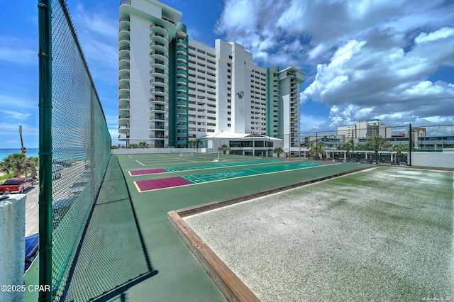 surrounding community featuring shuffleboard and fence