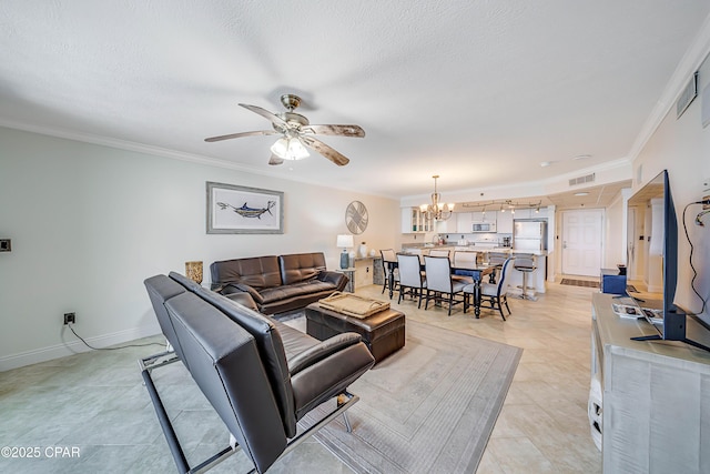 living area with a textured ceiling, ceiling fan with notable chandelier, visible vents, baseboards, and ornamental molding