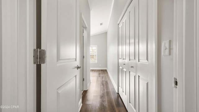 hall with dark hardwood / wood-style flooring and lofted ceiling