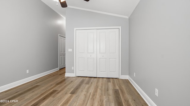 unfurnished bedroom with light hardwood / wood-style floors, vaulted ceiling, ceiling fan, and ornamental molding