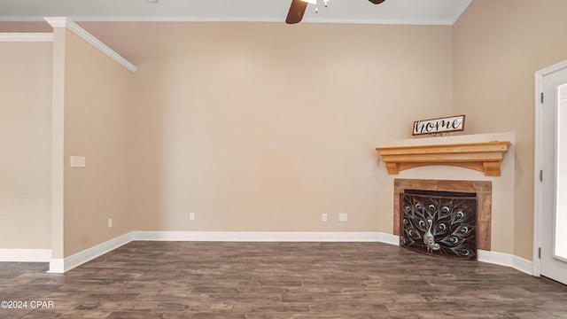 unfurnished living room with ceiling fan, crown molding, and dark wood-type flooring