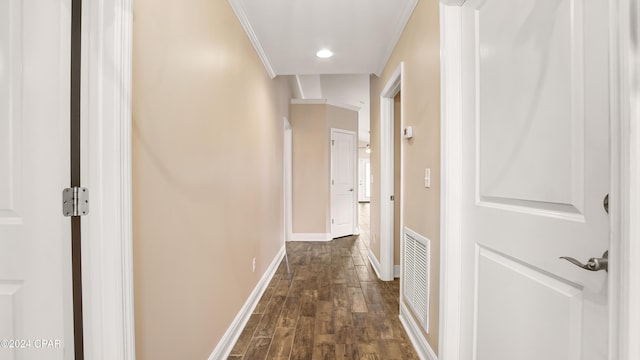 hallway with dark hardwood / wood-style floors and ornamental molding