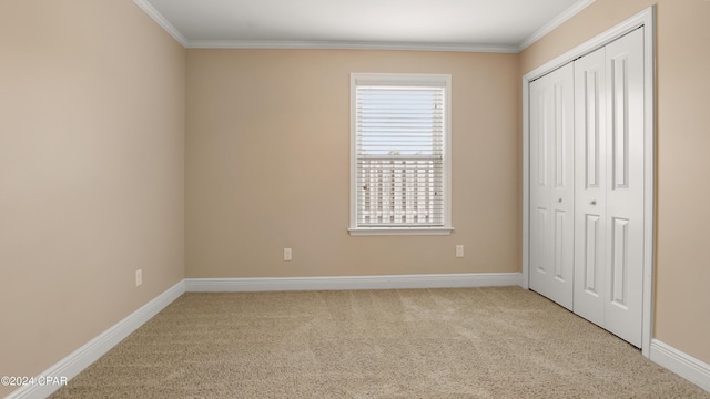 unfurnished bedroom with light carpet, a closet, and ornamental molding