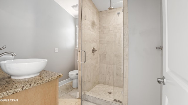 bathroom featuring sink, crown molding, tile patterned flooring, toilet, and an enclosed shower