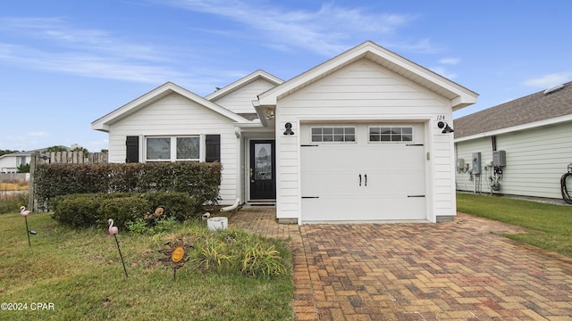 view of front of home featuring a front lawn and a garage