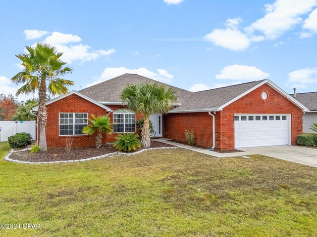 ranch-style house with a front yard and a garage