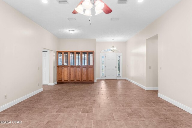 interior space featuring french doors, a textured ceiling, and ceiling fan