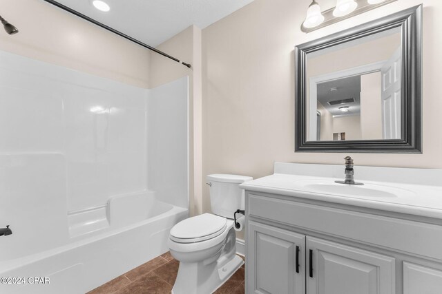 full bathroom featuring tile patterned floors, shower / washtub combination, vanity, and toilet