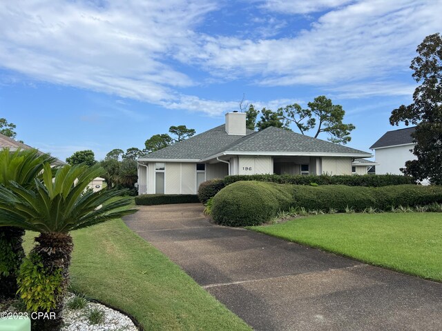 ranch-style home with a front lawn