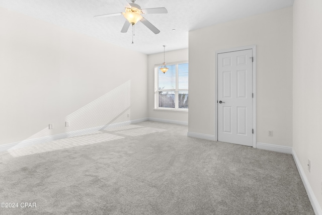 empty room with carpet flooring and ceiling fan