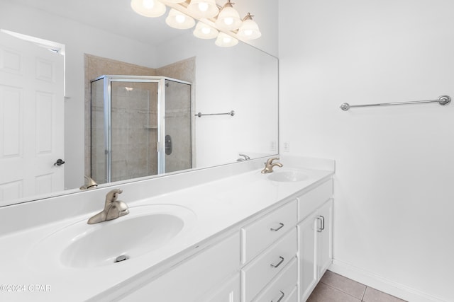 bathroom with tile patterned flooring, vanity, and a shower with shower door