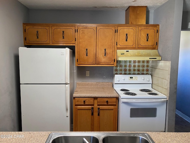 kitchen with white appliances and backsplash