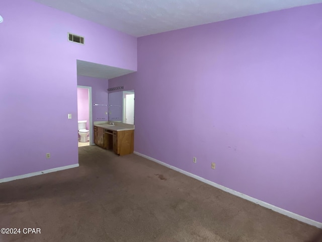 empty room with sink and dark carpet