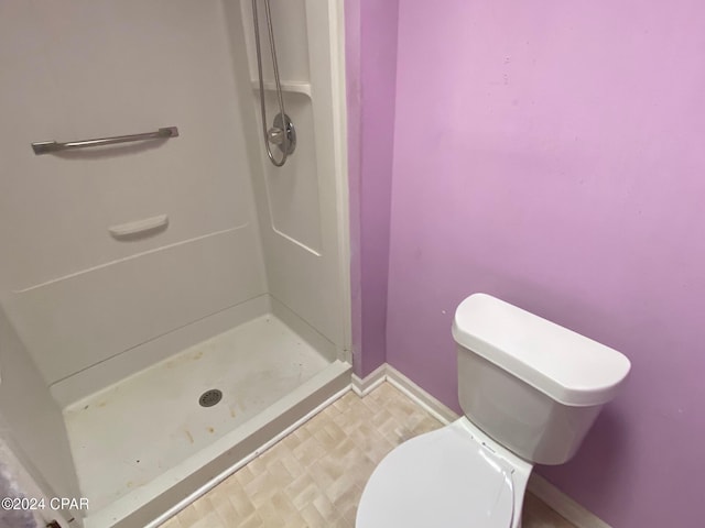 bathroom with toilet and walk in shower