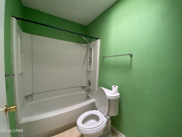 bathroom with washtub / shower combination and toilet